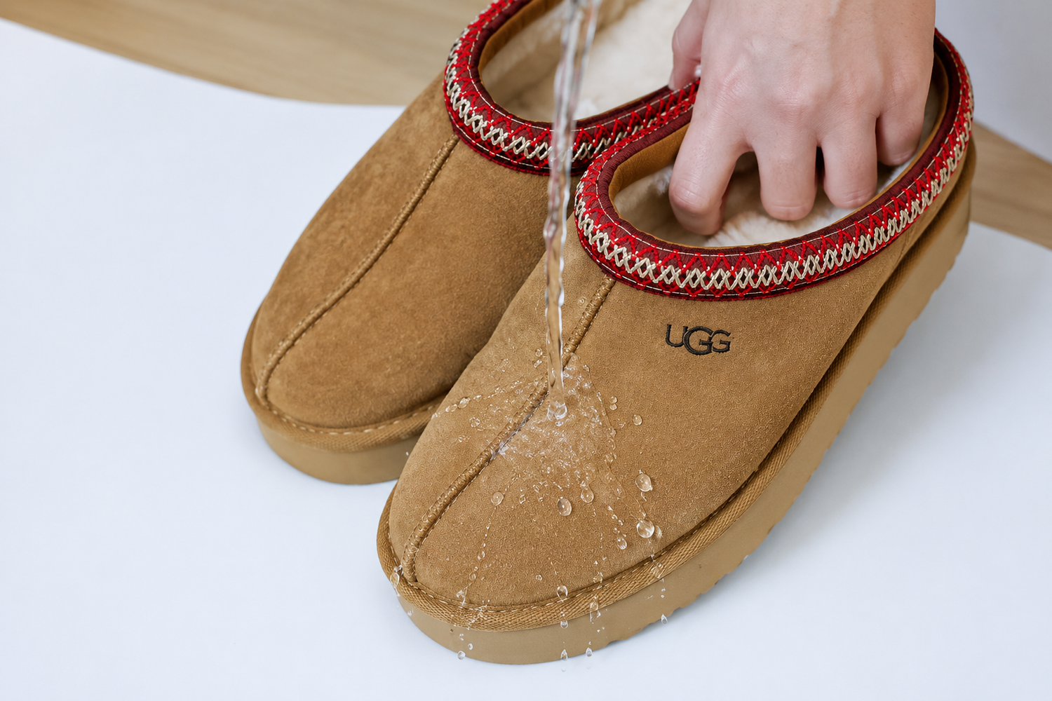 M&B Suede & Nubuck Protector is being sprayed on a pair of UGG Tasman's to protect from rain.